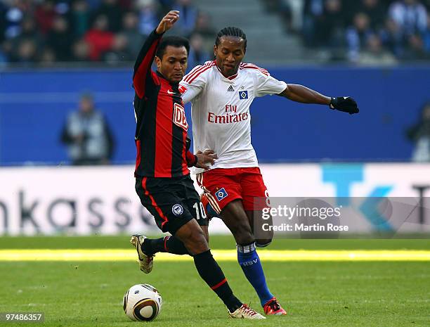 Ze Roberto of Hamburg and Raffael of Berlin compete for the ball during the Bundesliga match between Hamburger SV and Hertha BSC Berlin at HSH...