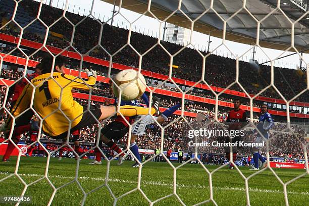 Benedikt Hoewedes of Schalke scores the second goal against Oka Nikolov of Frankfurt during the Bundesliga match between Eintracht Frankfurt and FC...