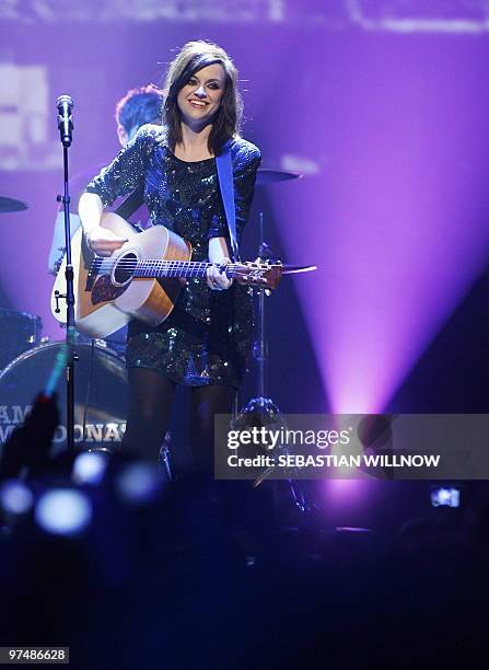Scottish musician Amy Macdonald performs on stage at the "The Dome" music show in Berlin on March 5, 2010. AFP PHOTO DDP / SEBASTIAN WILLNOW GERMANY...