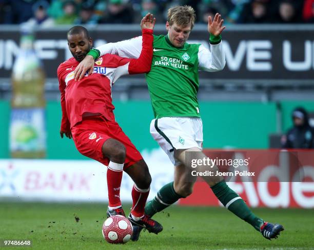 Per Mertesacker of Bremen and Cacau of Stuttgart compete for the ball during the Bundesliga match between Werder Bremen and VfB Stuttgart at Weser...