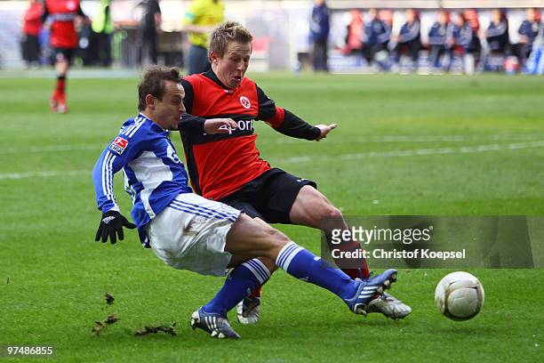 Christoph Spycher of Frankfurt tackles Rafinha of Schalke during the Bundesliga match between Eintracht Frankfurt and FC Schalke at the Commerzbank...