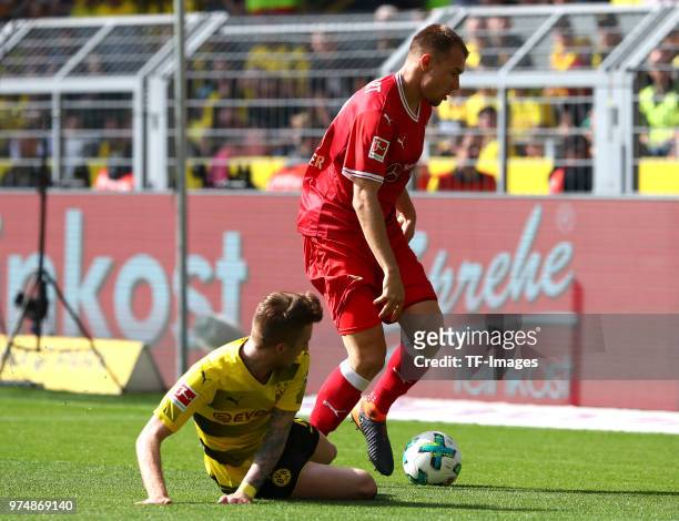 Marco Reus of Dortmund and Holger Badstuber of Stuttgart battle for the ball during the Bundesliga match between Borussia Dortmund and VfB Stuttgart...