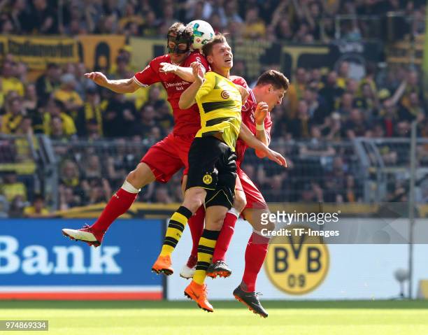 Christian Gentner of Stuttgart and Lukasz Piszczek of Dortmund, Mario Gomez of Stuttgart battle for the ball during the Bundesliga match between...