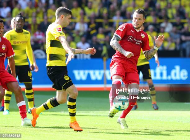 Christian Pulisic of Dortmund and Daniel Ginczek of Stuttgart battle for the ball during the Bundesliga match between Borussia Dortmund and VfB...