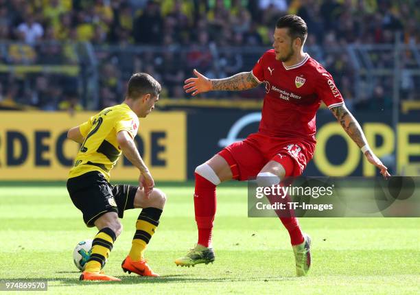 Christian Pulisic of Dortmund and Daniel Ginczek of Stuttgart battle for the ball during the Bundesliga match between Borussia Dortmund and VfB...