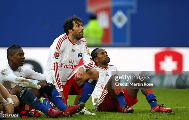 Eljero Elia, Ruud van Nistelrooy and Ze Roberto of Hamburg look dejected after the Bundesliga match between Hamburger SV and Hertha BSC Berlin at HSH...