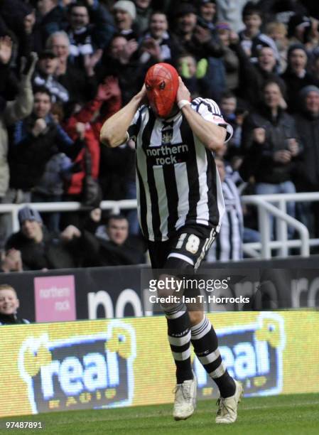 Jonas Gutierrez dons his Spider Man mask after he scored the fourth goal during the Coca-Cola championship match between Newcastle United and...