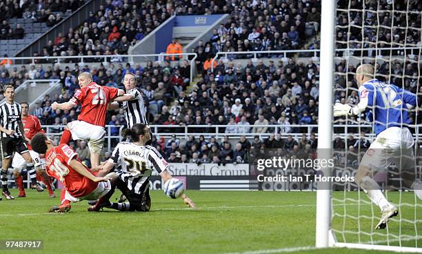 Andy Carroll claims a flick on the ball but the fifth goal comes from a Danny Guthrie free kick during the Coca-Cola championship match between...