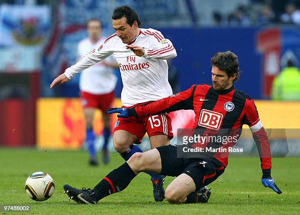 Piotr Trochowski of Hamburg and Arne Friedrich of Berlin compete for the ball during the Bundesliga match between Hamburger SV and Hertha BSC Berlin...