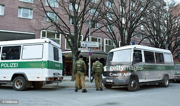 Police vehicles are parked in front of the Grand Hyatt Hotel at Potsdamer Plarz in Berlin on March 6, 2010. Armed robbers raided a poker competition...