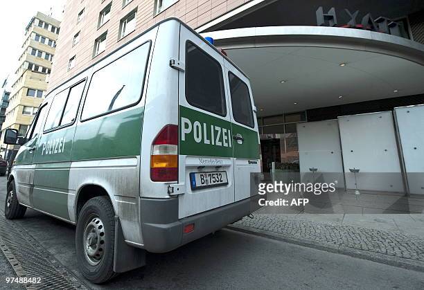 Police vehicle is parked in front of the Grand Hyatt Hotel at Potsdamer Plarz in Berlin on March 6, 2010. Armed robbers raided a poker competition...