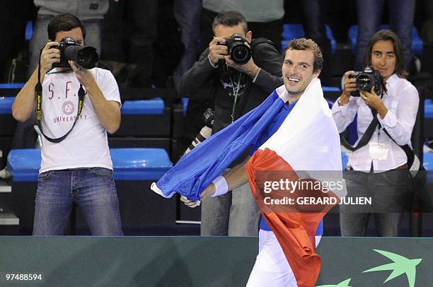 French player Julien Benneteau celebrates after he won with his team mate Michael Llodra against German players Christopher Kas and Philipp...