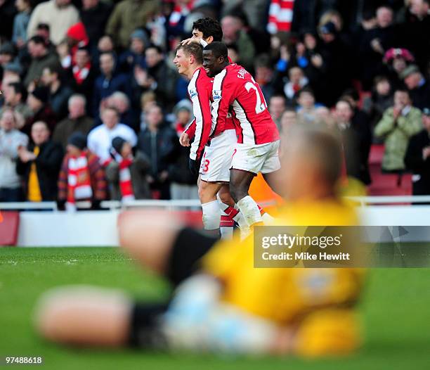 Goalscorer Andre Arshavin of Arsenal is congratulated by team mates Emmanuel Eboue and Eduardo as Brian Jensen of Burnley lies in the foreground...