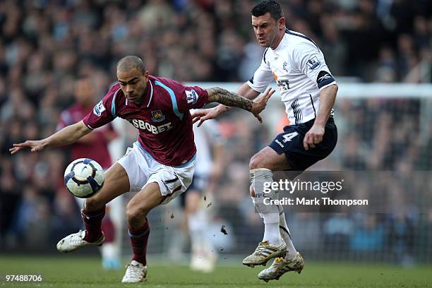 Kieron Dyer of West Ham United tangles with Paul Robinson of Bolton Wanderers during the Barclays Premier League match between West Ham United and...