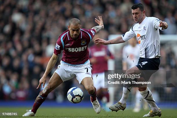 Kieron Dyer of West Ham United tangles with Paul Robinson of Bolton Wanderers during the Barclays Premier League match between West Ham United and...