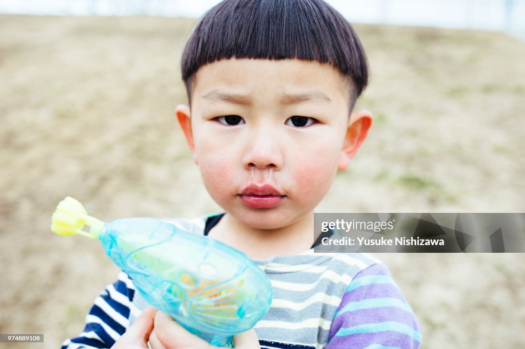 A boy who sees a point with a toy