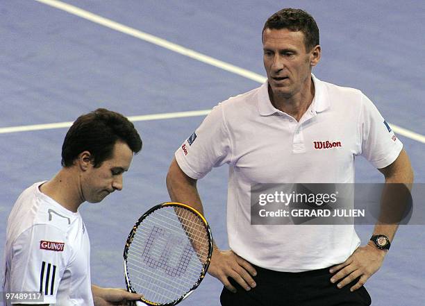 German team captain Patrick Kuhnen speaks with German player Philipp Kohlschreiber at the end of the Davis Cup first-round tie tennis match on March...