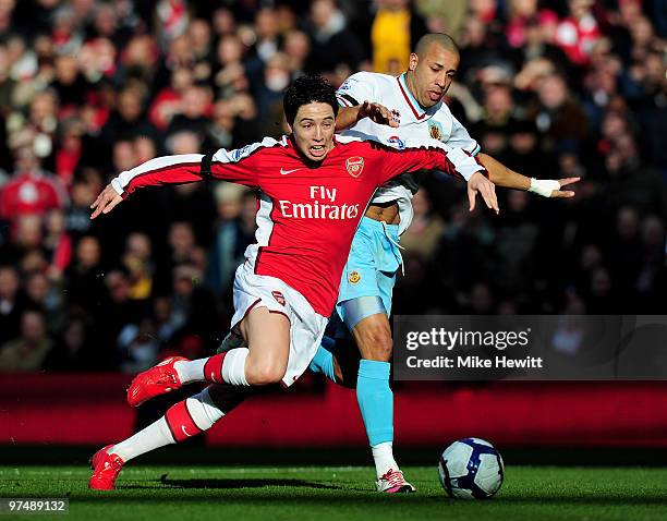 Samir Nasri of Arsenal is challenged by Tyrone Mears of Burnley during the Barclays Premier League match between Arsenal and Burnley at Emirates...