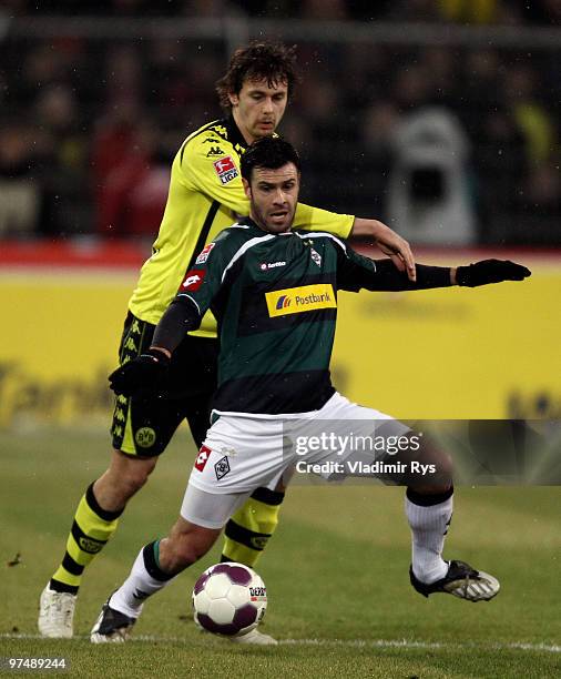 Roberto Colautti of Moenchengladbach and Neven Subotic of Dortmund battle for the ball during the Bundesliga match between Borussia Dortmund and...