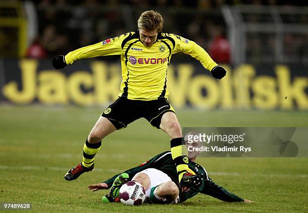 Michael Bradley of Moenchengladbach slides into Jakub Blaszczykowski of Dortmund during the Bundesliga match between Borussia Dortmund and Borussia...