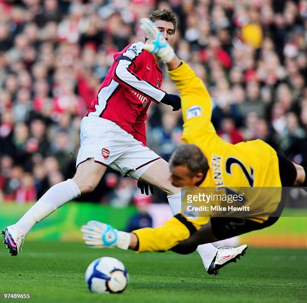 Nicklas Bendtner of Arsenal beats goalkeeper Brian Jensen of Burnley but puts the ball wide during the Barclays Premier League match between Arsenal...