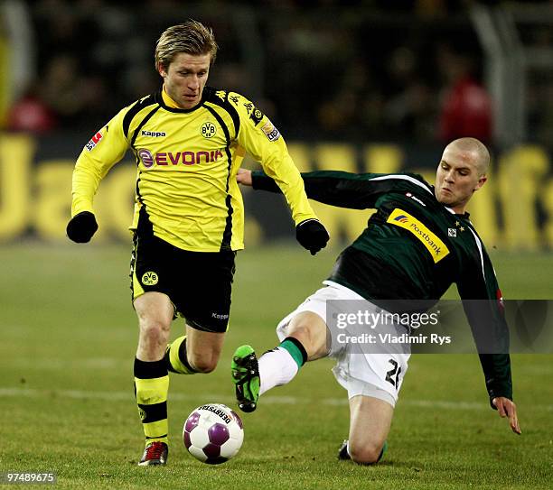 Michael Bradley of Moenchengladbach slides into Jakub Blaszczykowski of Dortmund during the Bundesliga match between Borussia Dortmund and Borussia...