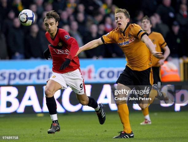 Dimitar Berbatov of Manchester United clashes with Christophe Berra of Wolverhampton Wanderers during the FA Barclays Premier League match between...