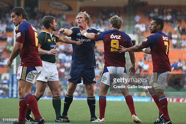 Schalk Burger from the Stormers pushes the referee Matk Lawrence and Jimmy Cowan from the Highlanders away during the Super 14 match between Stormers...