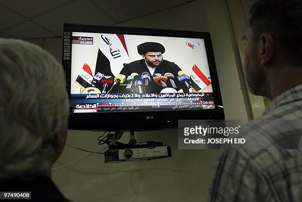 Journalists listen from their office in Baghdad on March 6, 2010 to Shiite cleric Moqtada al-Sadr as he speaks during a registered press conference....