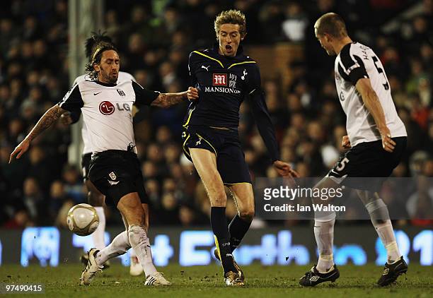 Peter Crouch of Tottenham Hotspur holds off the challenge of Jonathan Greening and Brede Hangeland of Fulham during the FA Cup sponsored by E.ON...