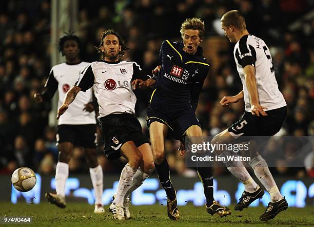 Peter Crouch of Tottenham Hotspur holds off the challenge of Jonathan Greening and Brede Hangeland of Fulham during the FA Cup sponsored by E.ON...