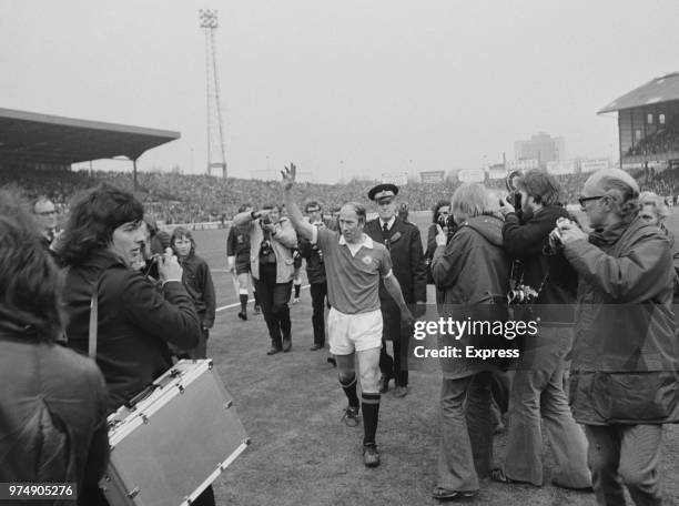 English soccer player Bobby Charlton of Manchester United FC greeting the crowd while leaving Stamford Bridge Stadium, London, UK, 28th April 1973....