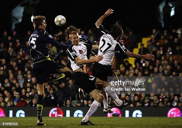 Peter Crouch of Tottenham Hotspur rises above the challenge of Jonathan Greening and Brede Hangeland of Fulham during the FA Cup sponsored by E.ON...