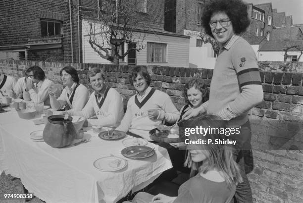 British architect Piers Gough serving his special meal to the Oxford Boat Race crew, UK, 30th March 1973.