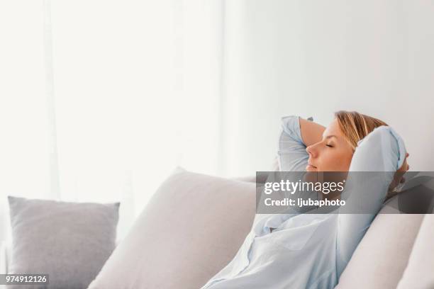 woman sleeping on vacations in an apartment - hands behind head stock pictures, royalty-free photos & images