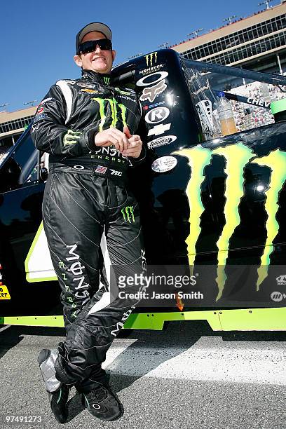 Ricky Carmichael, driver of the Monster Energy Chevrolet, stands on the grid prior to the start of the NASCAR Camping World Truck Series E-Z-GO 200...