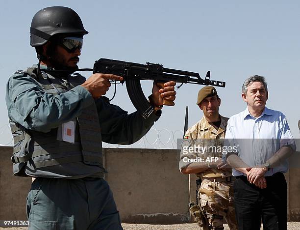Britain's Prime Minister Gordon Brown watches a display at the Helmand police training centre in Lashkar Gah, southern Afghanistan, March 6, 2010....