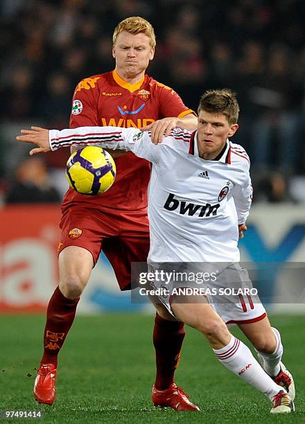 Milan's forward Marco Boriello fights for the ball against AS Roma's Norwegian defender John Arne Riise during their Italian Serie A football match...