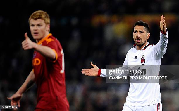 Milan's forward Marco Borriello gestures with AS Roma norwegian defender John Arne Riise during their Serie A football match in Rome's Olympic...