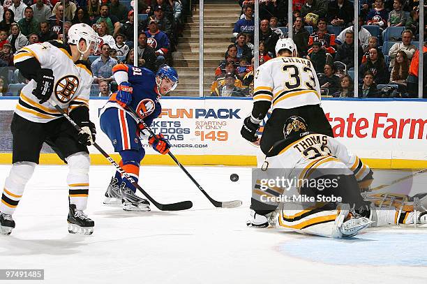 Goaltender Tim Thomas of the Boston Bruins makes a save off of John Tavares of the New York Islanders on February 6, 2010 at Nassau Coliseum in...