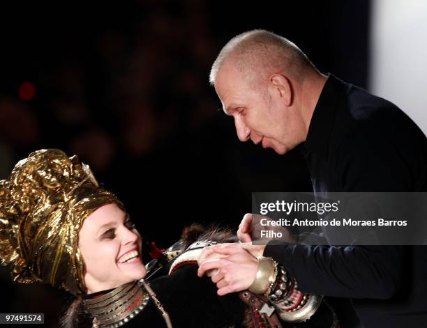 Designer Jean-Paul Gaultier and model Sasha Pivovarova greet each other on the runway at the end of the Jean-Paul Gaultier Ready to Wear show as part...