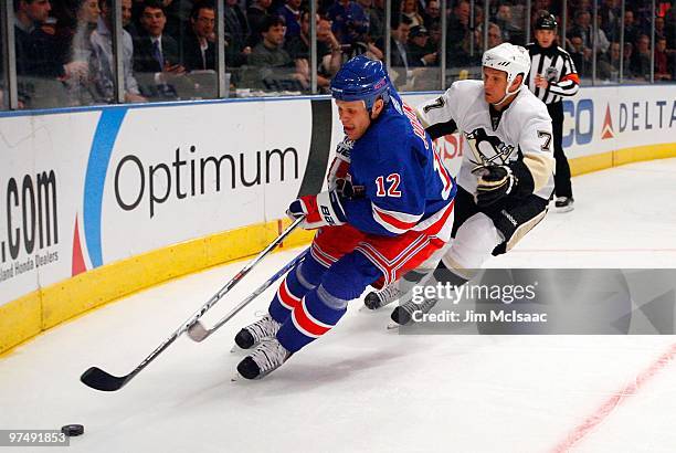 Olli Jokinen of the New York Rangers skates against Mark Eaton of the Pittsburgh Penguins on March 4, 2010 at Madison Square Garden in New York City....