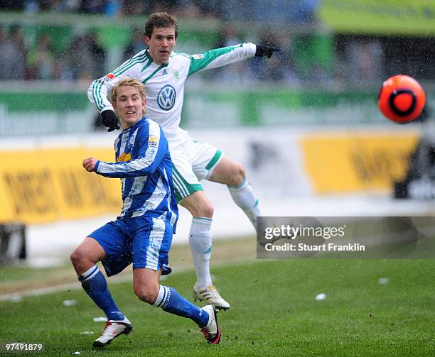 Peter Pekarik of Wolfsburg is challenged by Lewis Holtby of Bochum during the Bundesliga match between VfL Wolfsburg and VfL Bochum at Volkswagen...