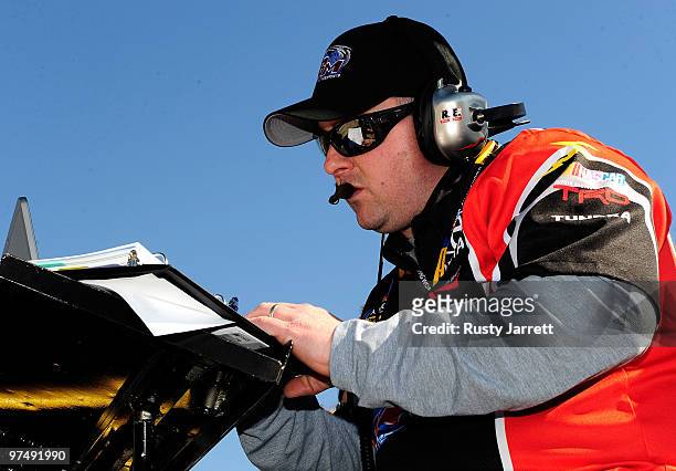 Eric Phillips, crew chief for the Toyota Tundra Toyota driven by Kyle Busch, makes notes after a pit stop during the NASCAR Camping World Truck...