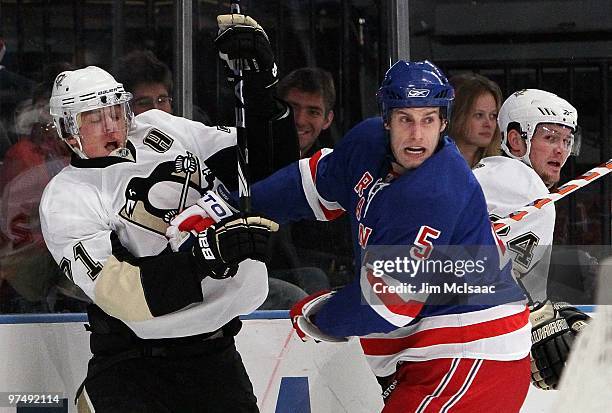 Dan Girardi of the New York Rangers skates against Evgeni Malkin of the Pittsburgh Penguins on March 4, 2010 at Madison Square Garden in New York...