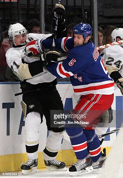 Dan Girardi of the New York Rangers skates against Evgeni Malkin of the Pittsburgh Penguins on March 4, 2010 at Madison Square Garden in New York...