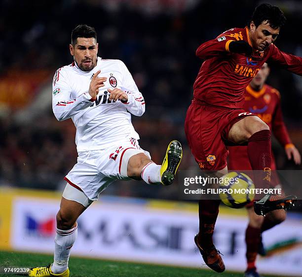 Milan's forward Marco Borriello vies for the ball with with AS Roma argentinian defender Nicolas Burdisso during their Seriews A football match in...