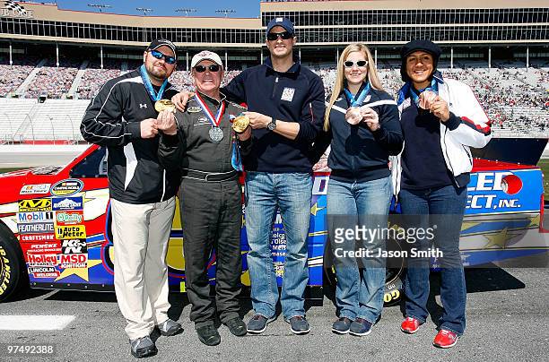 United States woman's bobsled driver Erin Pac , stands along side team brakeman Elana Meyers , NASCAR driver Geoff Bodine , head of the Bodine...