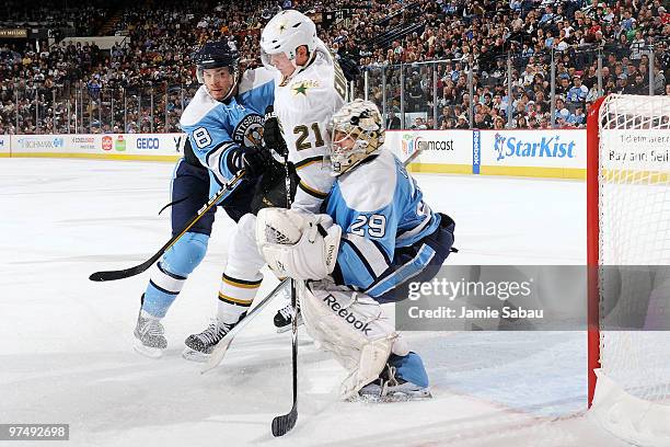 Forward Loui Eriksson of the Dallas Stars is pushed into goaltender Marc-Andre Fleury of the Pittsburgh Penguins by defenseman Kris Letang of the...