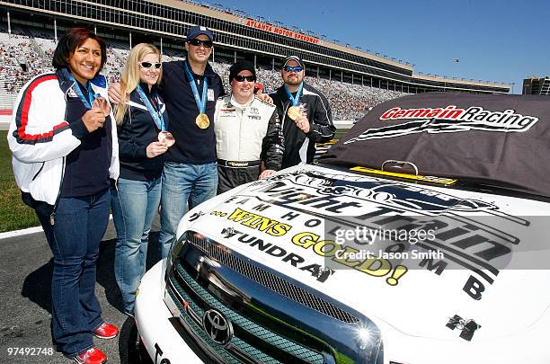 United States woman's bobsled driver Erin Pac , stands along side team brakeman Elana Meyers , NASCAR Truck series driver Todd Bodine , men's bobsled...